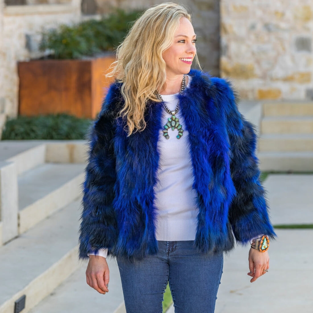 Woman smiling wearing cobalt blue fox fur bolero