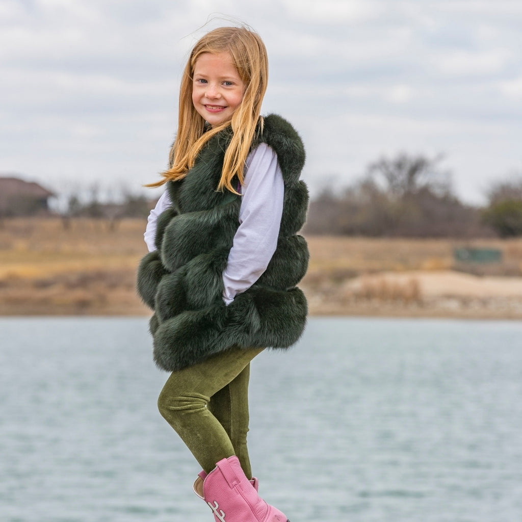 Little girl wearing emerald green fox fur vest